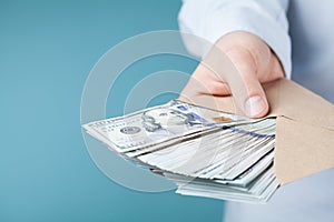 Businessman giving cash money. Loan, finance, salary, bribe and donate concept. photo