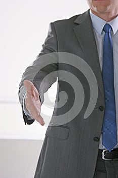 Businessman giving hand for handshake, isolated on white background