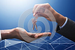 Businessman Giving Keys To Male Person