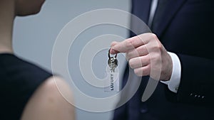 Businessman giving lady keys to Luxury accommodation, premium quality resort