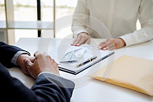 Businessman giving money while making deal to agreement a real e