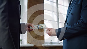 Businessman giving money partner at office meeting close up. Man receiving bribe