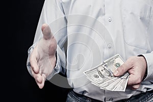 Businessman giving money, united states dollar (USD) bills â€“ c