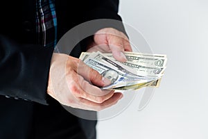 Businessman giving or paying money, US dollar bills - bribery, loan and financial concepts,