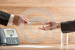 Businessman Giving Pen to Partner to Sign Contract