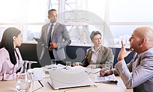 Businessman giving a presentation with electronic tablet in his hands