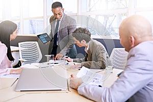 Businessman giving a presentation with electronic tablet in his hands