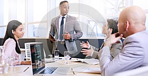 Businessman giving a presentation with electronic tablet in his hands