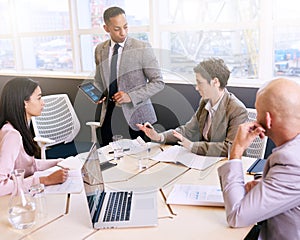 Businessman giving a presentation with electronic tablet in his hands