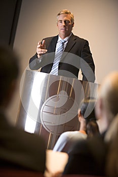 Businessman giving presentation at podium