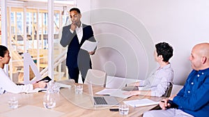 Businessman giving presentation to 3 board member in conference room