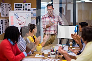 Businessman giving presentation to colleagues in office