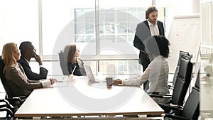 Businessman giving presentation to multi-ethnic clients group at office meeting