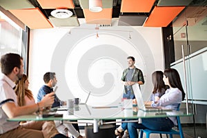 Businessman giving a sales pitch to team