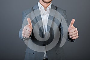 Businessman giving thumbs-up