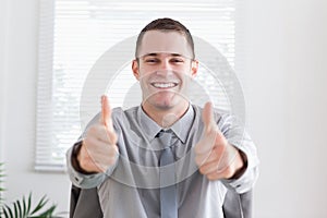 Businessman giving thumbs up