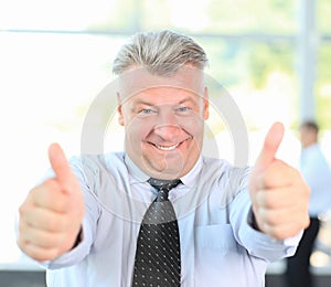 Businessman giving you thumbs up