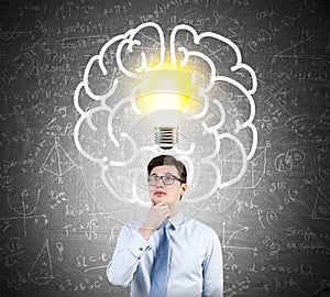 Businessman in glasses and giant brain icon