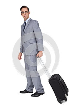 Businessman with glasses holding a trolley