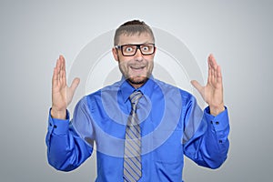 Businessman in glasses showing the big size of her hands. Here's a size concept