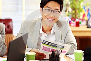 Businessman in glasses sitting at the table