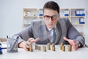 The businessman with golden coins in business growth concept