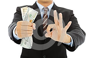 Businessman grasp us dollars with ok gesture photo