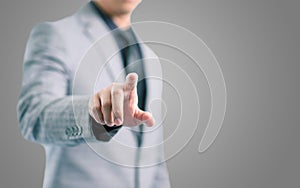 Businessman in gray suit is pointing his finger to touch the screen concept