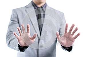 Businessman in gray suit is showing his two hands to stop something