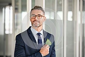 Businessman with green leaf in pocket