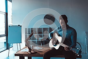 businessman with guitar in office
