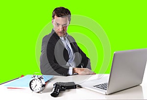 Businessman with gun and alarm clock in deadline concept isolated green chroma key