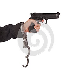 Businessman with gun and handcuffs