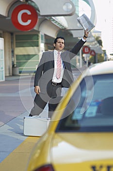 Businessman Hailing Taxi