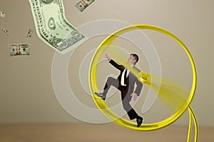 Businessman on hamster wheel chasing money success