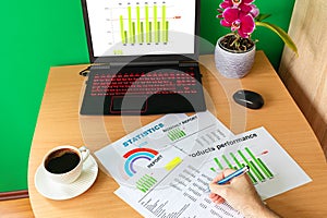 Businessman hand analysing financial report business graphs and charts