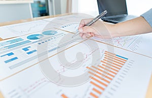 Businessman hand analyzing chart on paper investment charts with laptop. Accounting. Business concept