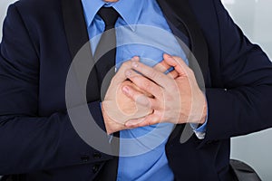 Businessman With Hand On Chest