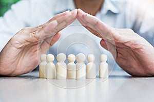 Businessman hand cover man wooden from crowd of employees. People, Business, Human resource management, Life Insurance, Teamwork