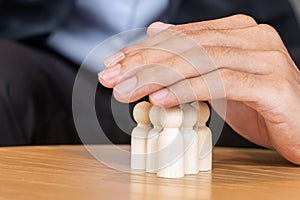 Businessman hand cover man wooden from crowd of employees. People, Business, Human resource management, Life Insurance, Teamwork