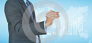 businessman hand drawing business graph