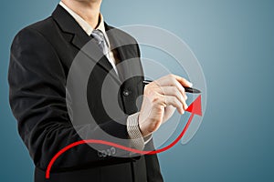 Businessman hand drawing chart red arrow