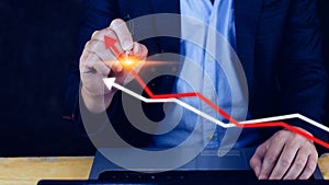 Businessman hand drawing touching rising red and white arrow, representing business growth