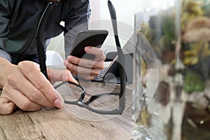 businessman hand with eyeglasses using smart phone,mobile payments online shopping,omni channel,digital tablet docking keyboard c