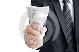 Businessman hand grabbing money, Thai Baht (THB)