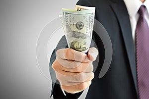 Businessman hand grabbing money, US dollar (USD) banknotes