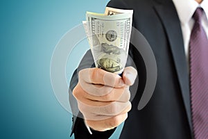 Businessman hand grabbing money, US dollar (USD) bills