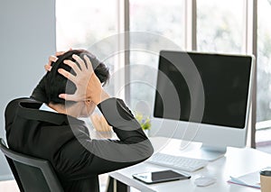 Businessman with hand on head disappoint to what show on the computer blank screen for template and mock up photo