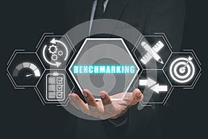 Businessman hand holding benchmarking icon on virtual screen