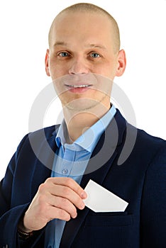 Businessman hand holding a business card over suit pocket, closeup. Isolated on white.